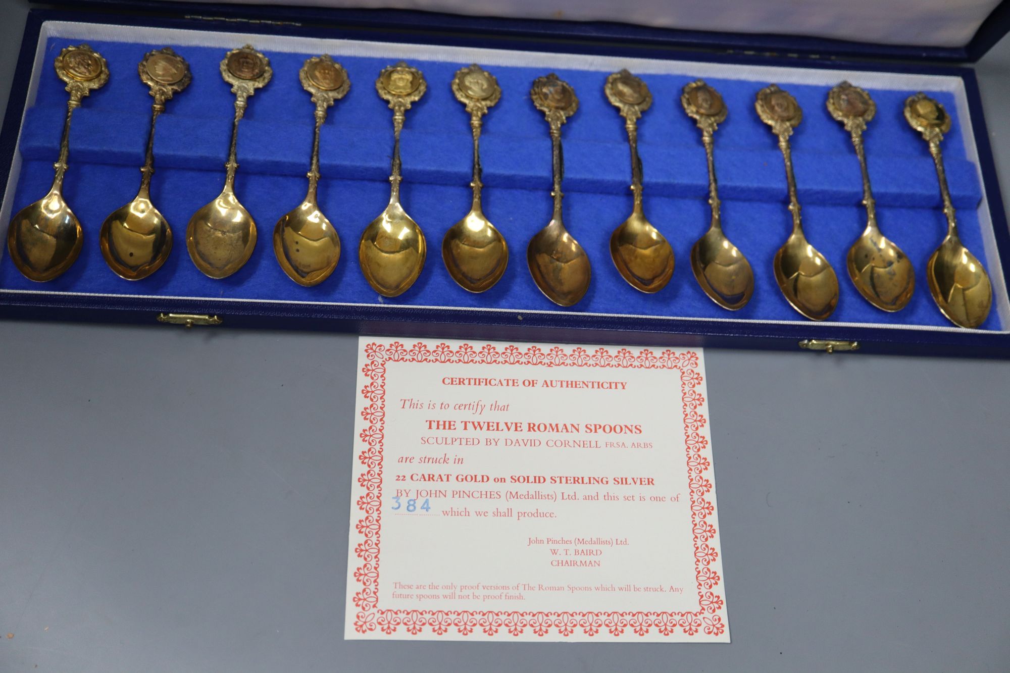 A set of The Twelve Roman silver gilt spoons, sculpted by David Cornell, one of a limited edition of 384, cased,